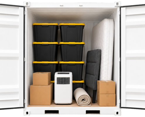 Seasonal-Storage-Container Open storage container with stacked plastic bins, cardboard boxes, a rolled-up rug, an air conditioner, a mattress, and a folded sofa packed neatly inside.